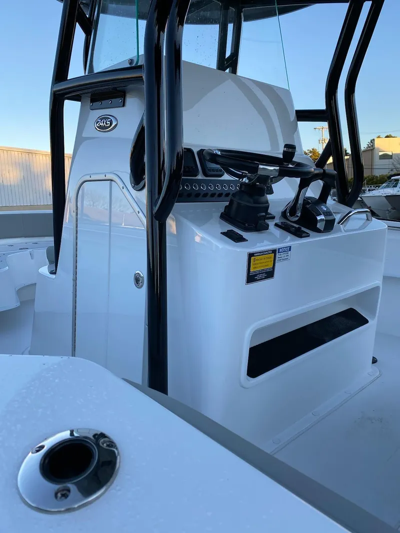 Slide: The Image of 2024 Cape Horn 24 XS center console boat with modern controls and sleek design. - 12
