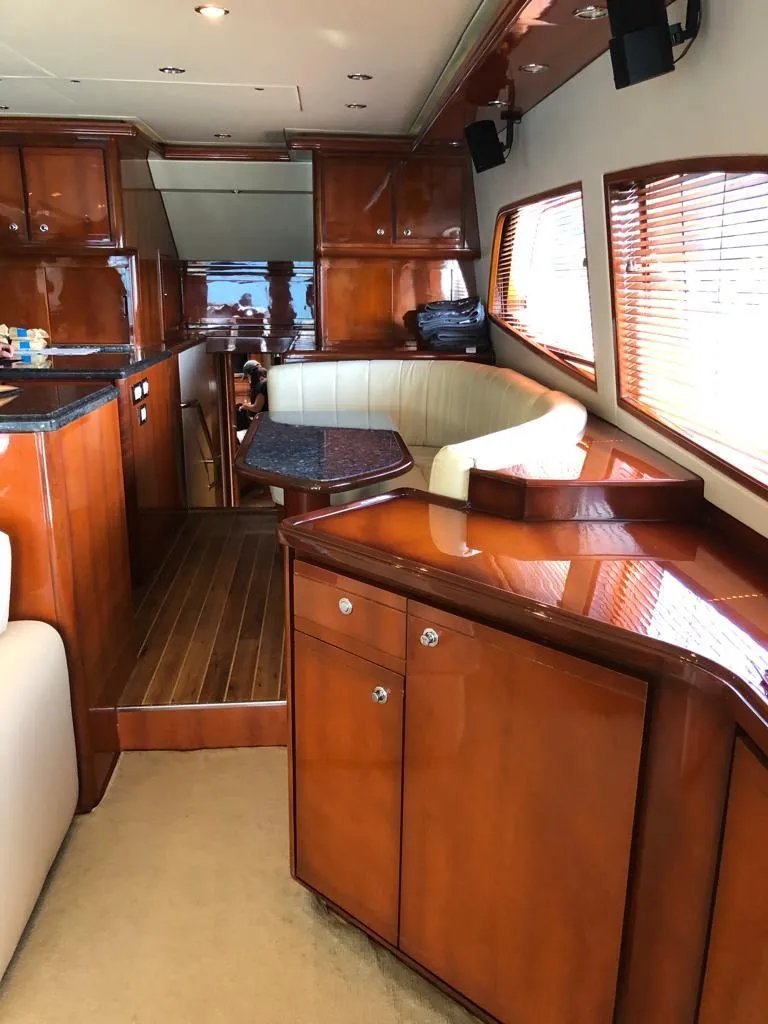 Slide: The Image of Luxurious interior of a 2005 Bertram 570 yacht with polished wood finishes. - 6