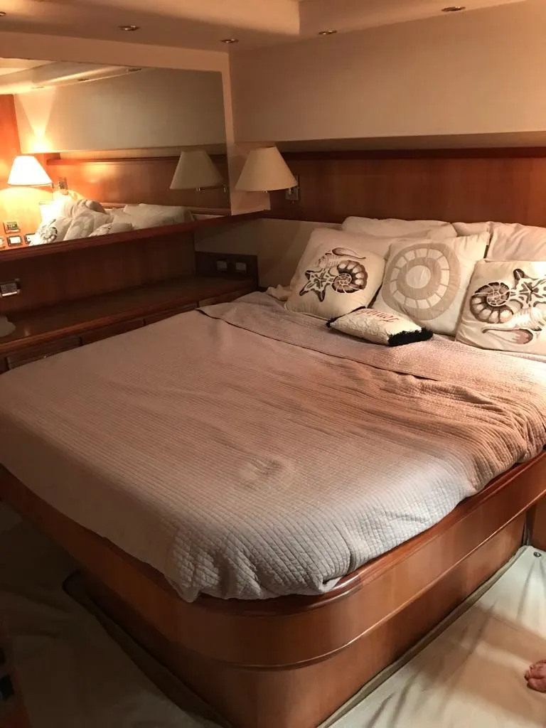 Slide: The Image of Luxurious bedroom interior of a 2005 Bertram 570 yacht. - 7