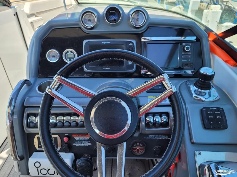 Slide: The Image of 2014 Formula 290 BR boat dashboard with steering wheel, gauges, and navigation controls. - 11