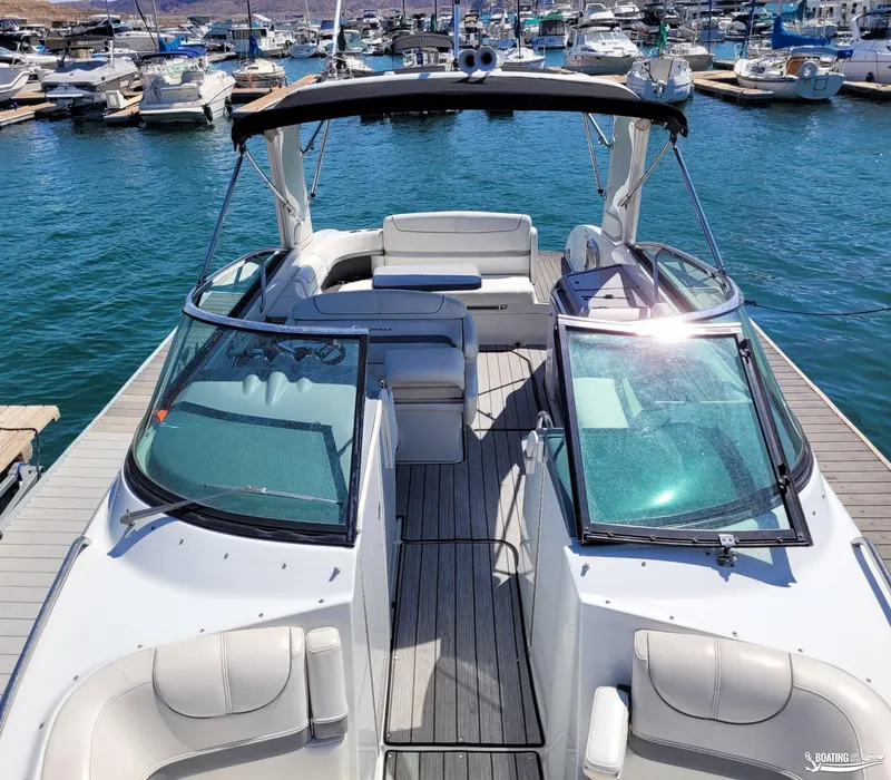 Slide: The Image of 2014 Formula 290 BR boat docked at a marina, featuring spacious seating and sleek design. - 12