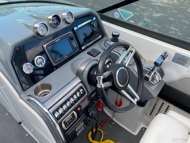 Slide: The Image of 2014 Formula 290 BR boat dashboard with steering wheel, gauges, and navigation system. - 15