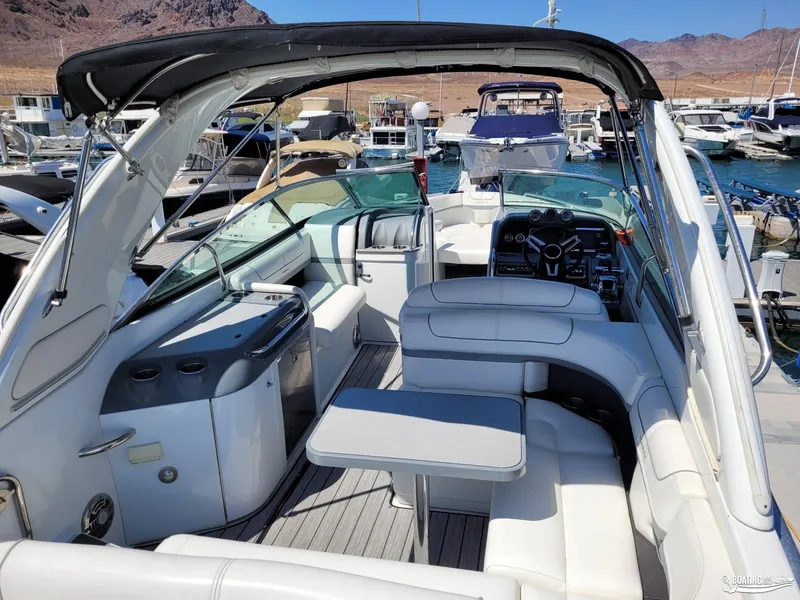 Slide: The Image of 2014 Formula 290 BR boat interior with seating and helm at marina. - 18
