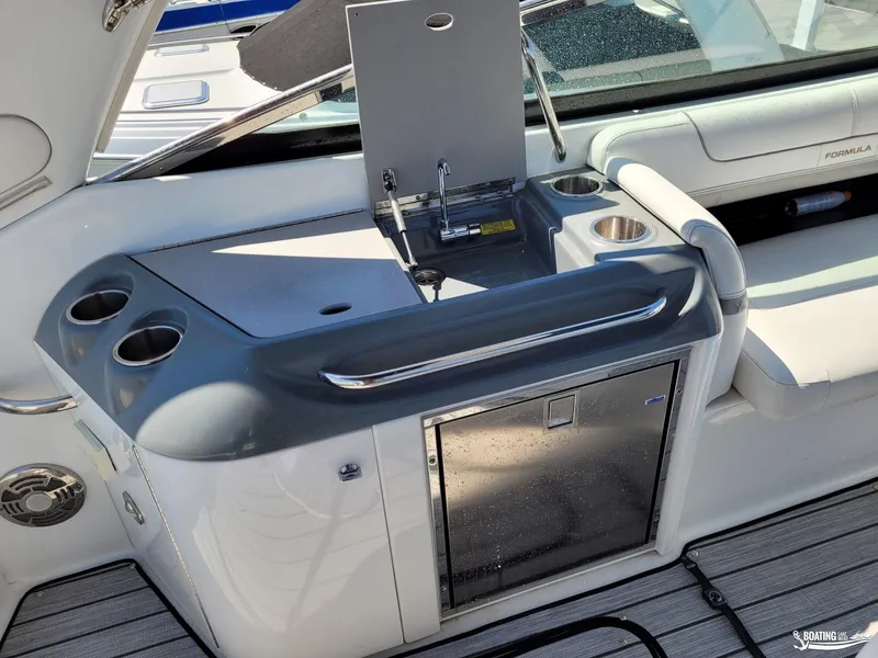 Slide: The Image of 2014 Formula 290 BR boat interior with kitchenette and seating area. - 19