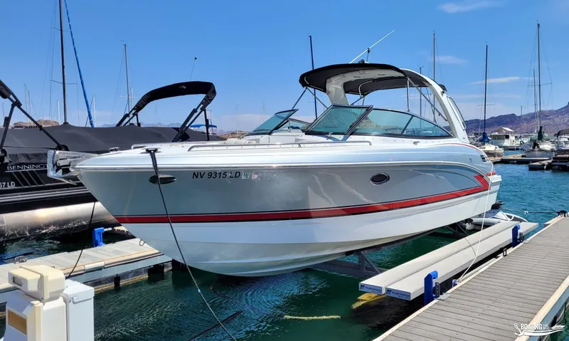 Slide: The Image of 2014 Formula 290 BR boat docked at marina on HydroHoist lift. - 2