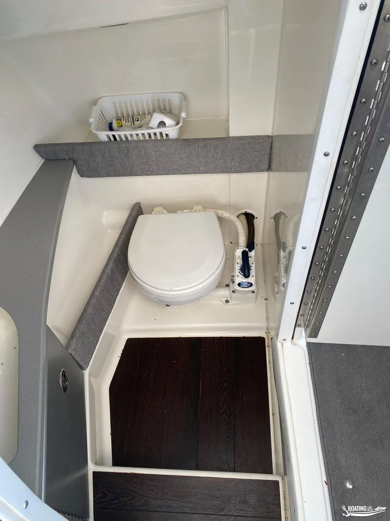 Slide: The Image of 2014 Formula 290 BR boat bathroom with toilet and storage basket. - 22
