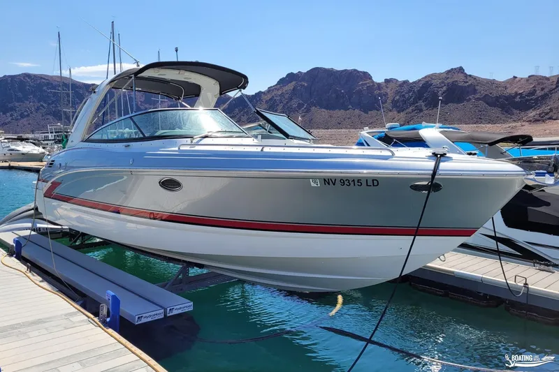 Slide: The Image of 2014 Formula 290 BR boat docked at marina with mountainous background. - 3
