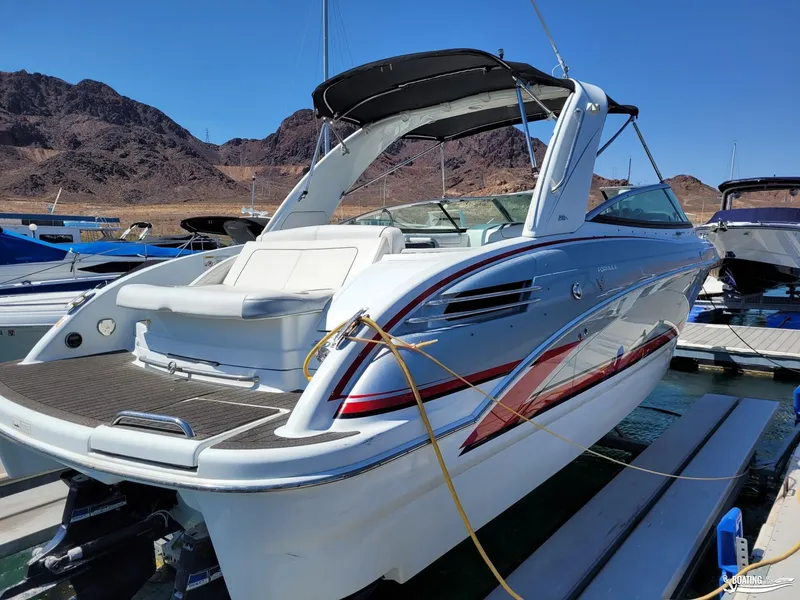 Slide: The Image of 2014 Formula 290 BR boat docked at marina with mountainous background. - 4