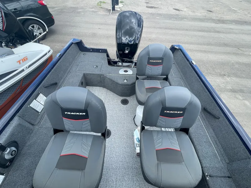 Slide: The Image of 2021 Tracker Pro Guide V-16 WT boat interior with four seats and motor. - 10