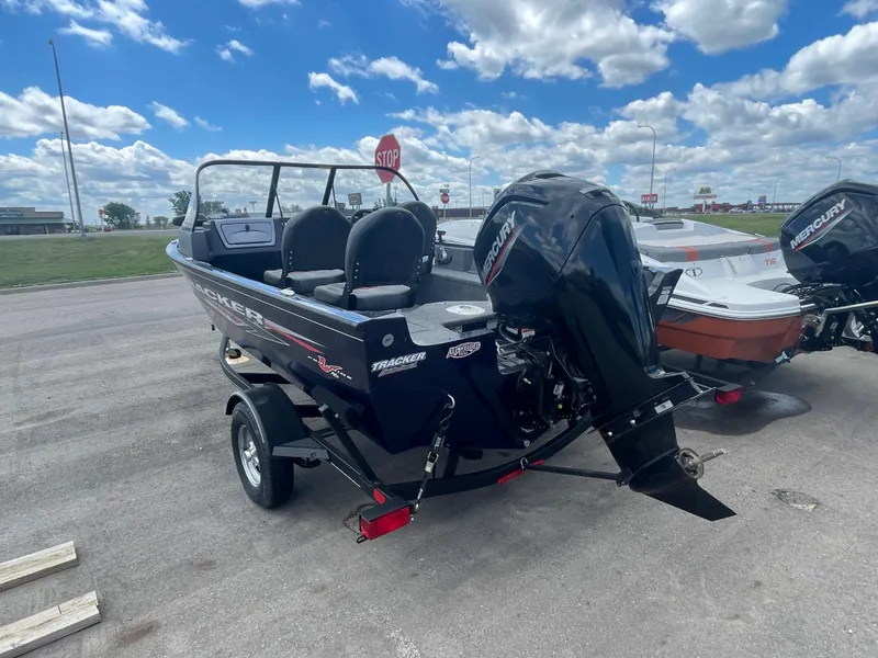 Slide: The Image of 2021 Tracker Pro Guide V-16 WT boat with Mercury outboard motor on trailer. - 4