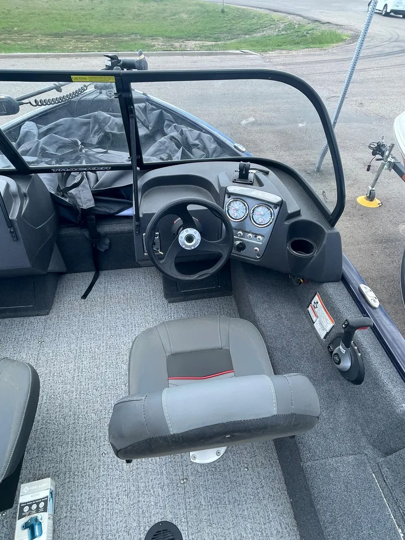 Slide: The Image of 2021 Tracker Pro Guide V-16 WT boat interior with steering console and seating. - 7