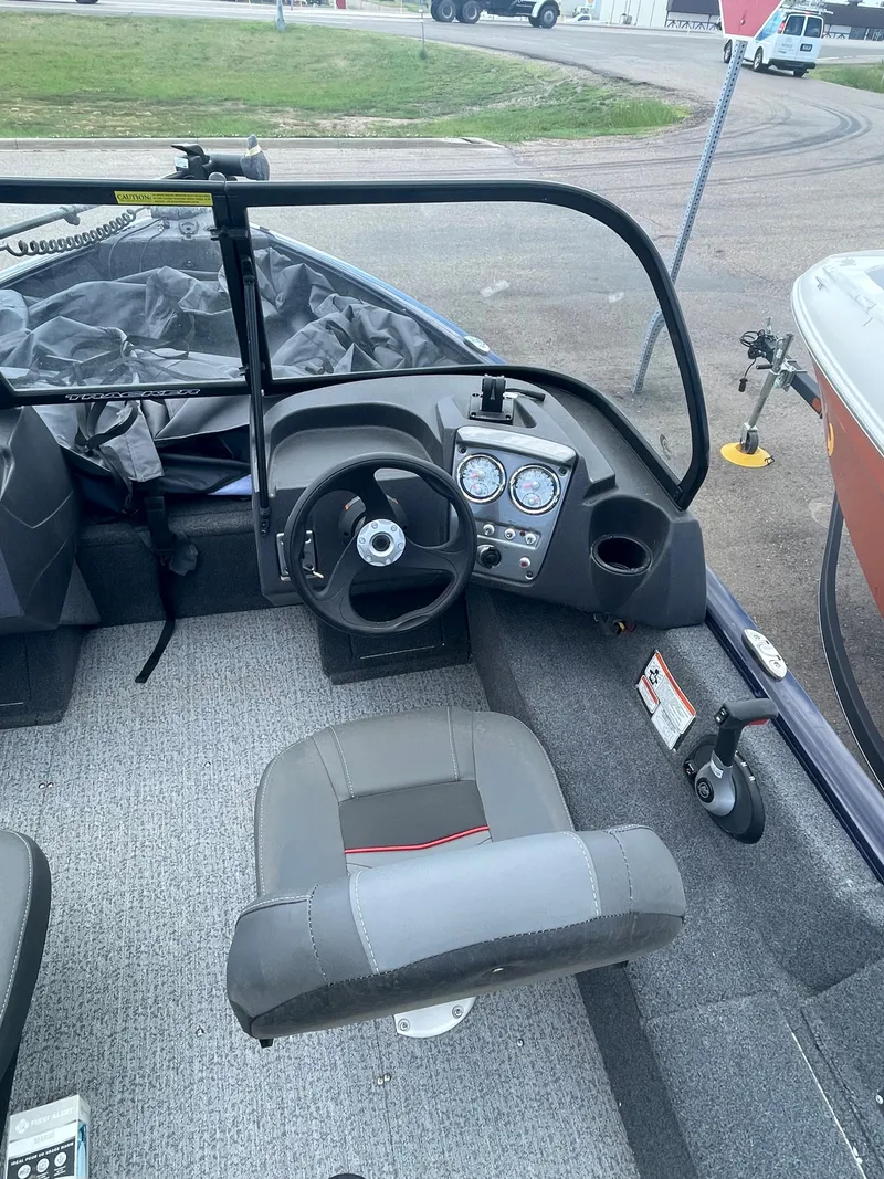 Slide: The Image of 2021 Tracker Pro Guide V-16 WT boat interior with steering wheel and dashboard. - 8