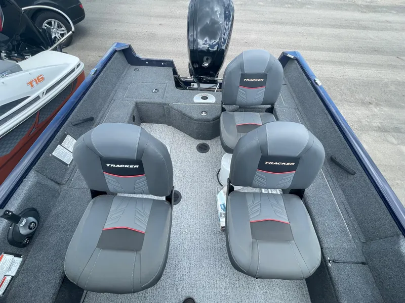 Slide: The Image of 2021 Tracker Pro Guide V-16 WT boat interior with four seats and motor. - 9