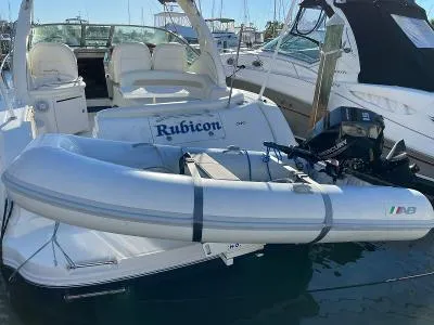 Slide: The Image of 2005 Sea Ray 340 Sundancer with dinghy in harbor. - 2