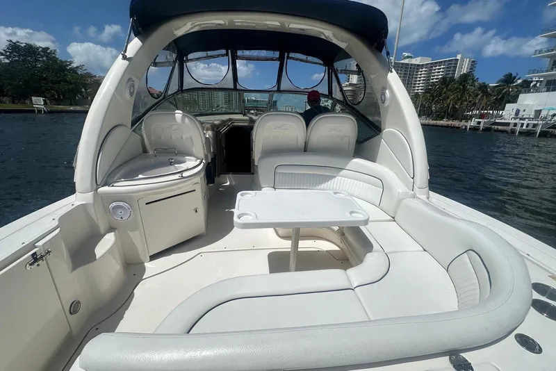 Slide: The Image of 2005 Sea Ray 340 Sundancer boat interior with seating and table on the water. - 59