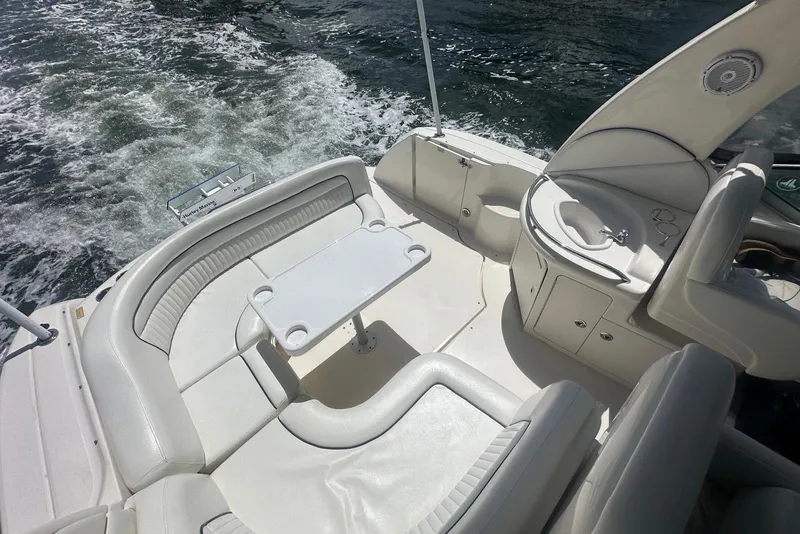 Slide: The Image of 2005 Sea Ray 340 Sundancer boat interior with seating and table on water. - 60