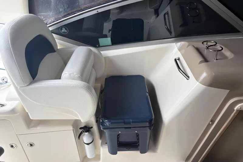 Slide: The Image of 2005 Sea Ray 340 Sundancer cockpit with white seating and storage area. - 62