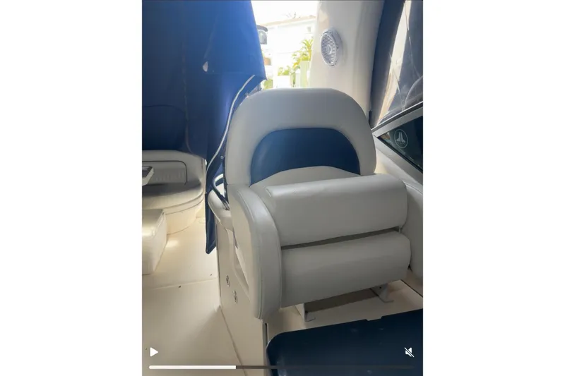 Slide: The Image of Interior seating of a 2005 Sea Ray 340 Sundancer boat, featuring white and blue upholstery. - 64