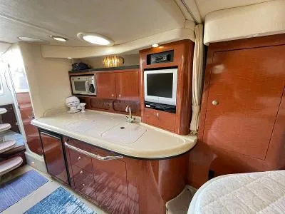 Slide: The Image of Interior of 2005 Sea Ray 340 Sundancer with kitchen and TV. - 8