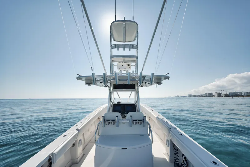 Slide: The Image of 2010 Jupiter 38 CC boat on calm ocean, clear sky, and distant city skyline. - 11