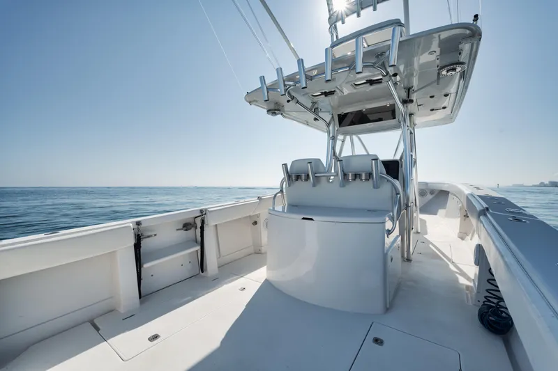 Slide: The Image of 2010 Jupiter 38 CC boat on open water, featuring a sleek center console design. - 14