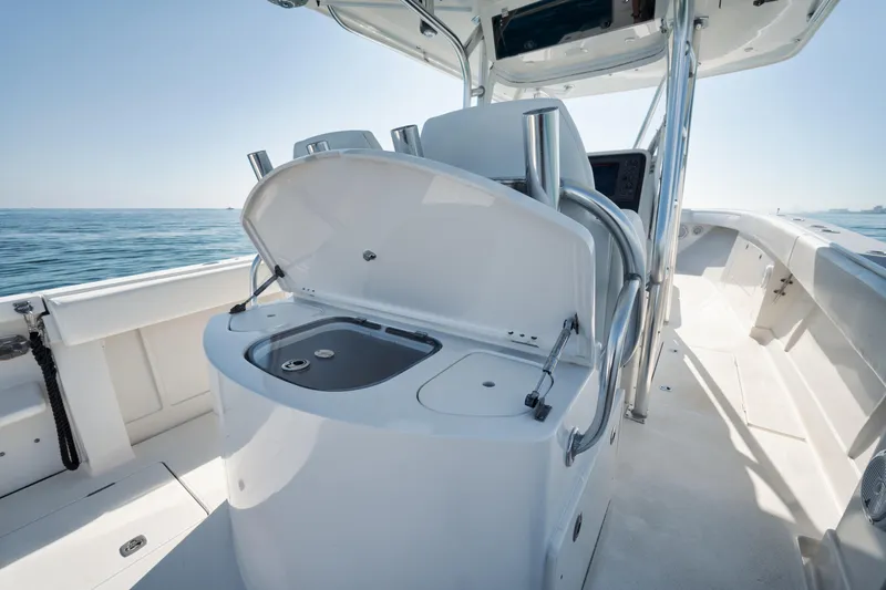 Slide: The Image of 2010 Jupiter 38 CC boat interior with open storage compartment, ocean view. - 15