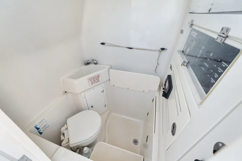 Slide: The Image of Compact marine bathroom in 2010 Jupiter 38 CC boat, featuring toilet and sink. - 16
