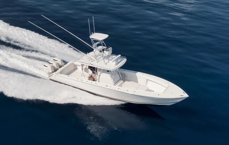 Slide: The Image of 2010 Jupiter 38 CC boat cruising on open water, aerial view. - 2