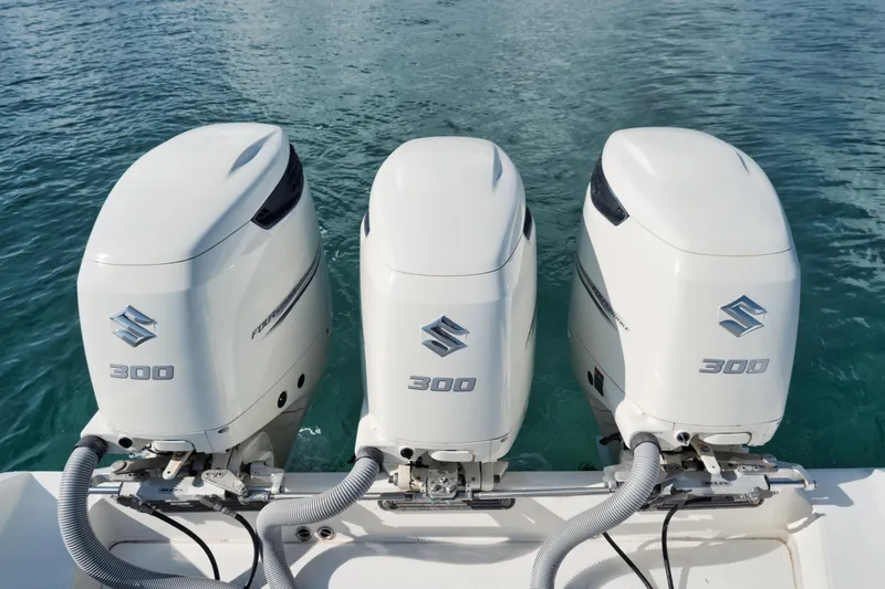 Slide: The Image of Triple Suzuki 300 outboard engines on a 2010 Jupiter 38 CC boat. - 22