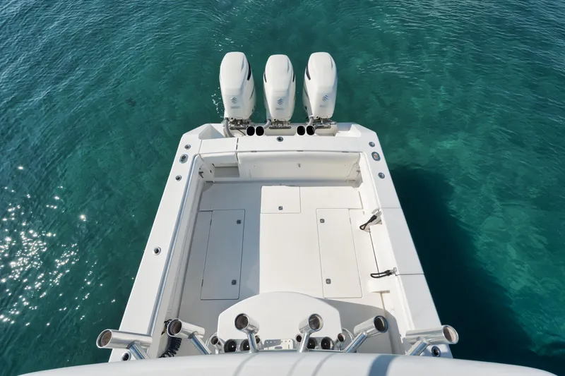 Slide: The Image of 2010 Jupiter 38 CC boat with triple outboard engines on clear blue water. - 5