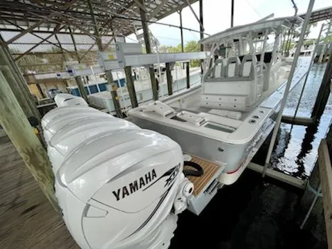 Slide: The Image of 2020 Regulator 41 boat with Yamaha engines docked in a covered marina. - 10