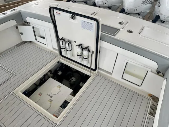 Slide: The Image of 2020 Regulator 41 boat deck with open hatch and fire extinguishers. - 11