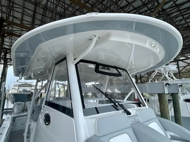 Slide: The Image of 2020 Regulator 41 boat with hardtop and seating, docked in a marina. - 14