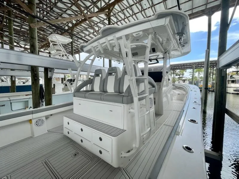 Slide: The Image of 2020 Regulator 41 boat with seating and storage, docked in a covered marina. - 16