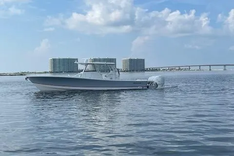 Slide: The Image of 2020 Regulator 41 boat on calm water with cityscape background. - 19