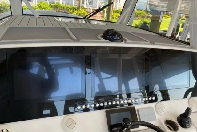 Slide: The Image of 2020 Regulator 41 boat dashboard with navigation screens and controls. - 2