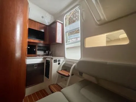 Slide: The Image of Interior of a 2020 Regulator 41 boat with kitchenette and seating area. - 21