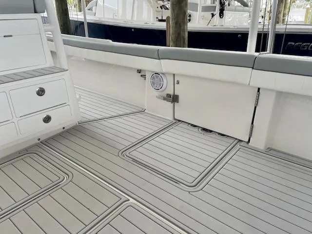 Slide: The Image of 2020 Regulator 41 boat interior with cushioned seating and storage compartments. - 9