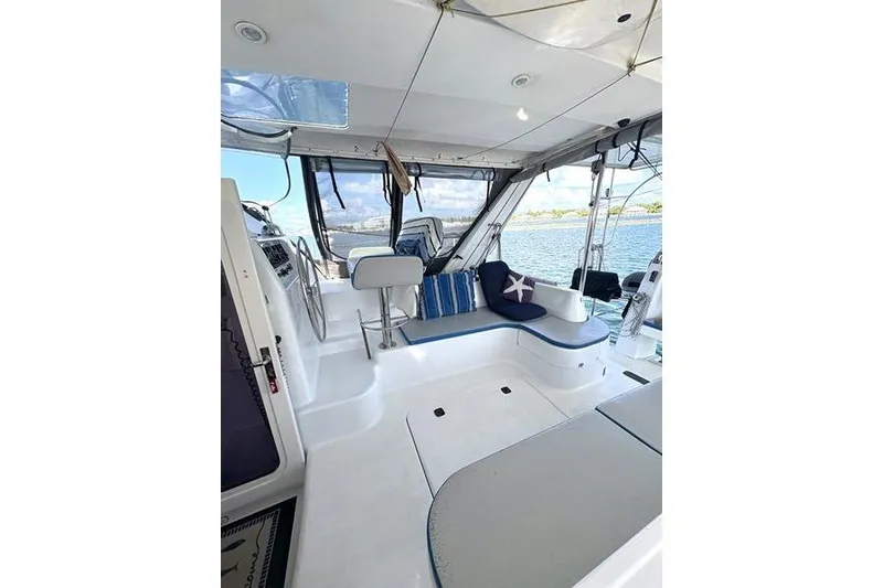 Slide: The Image of 1998 Leopard Catamaran interior with seating, steering wheel, and ocean view. - 11