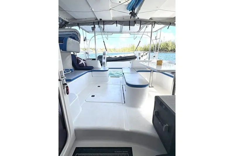 Slide: The Image of 1998 Leopard Catamaran interior with seating, table, and ocean view. - 15