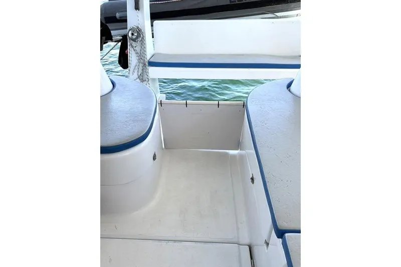 Slide: The Image of Interior view of a 1998 Leopard Catamaran with blue and white seating. - 17
