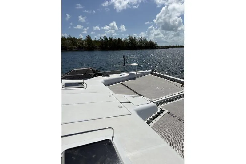 Slide: The Image of 1998 Leopard Catamaran on calm water with clear skies and distant trees. - 19