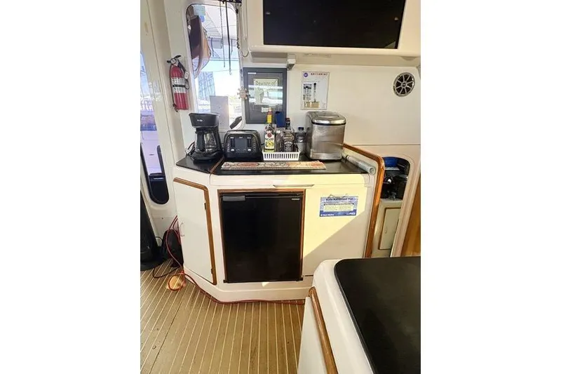 Slide: The Image of 1998 Leopard Catamaran kitchen area with appliances and storage. - 23