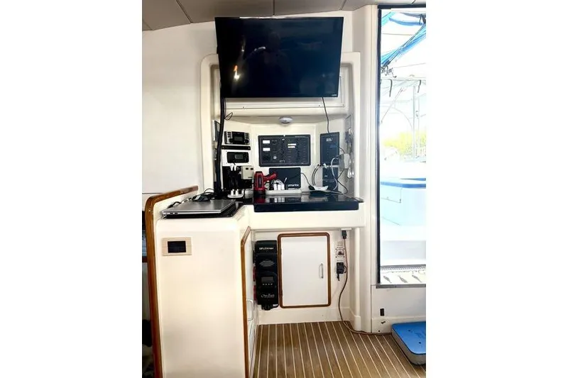 Slide: The Image of Interior of a 1998 Leopard Catamaran with navigation equipment and a mounted TV. - 29