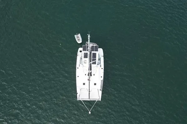 Slide: The Image of Overhead view of a 1998 Leopard Catamaran on calm water. - 4