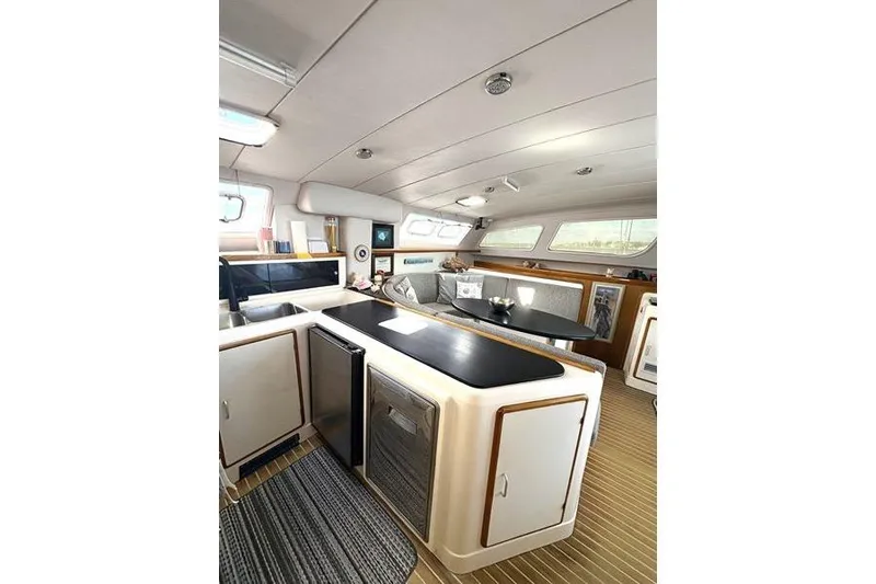 Slide: The Image of Interior of a 1998 Leopard Catamaran featuring a modern kitchen and cozy seating area. - 40
