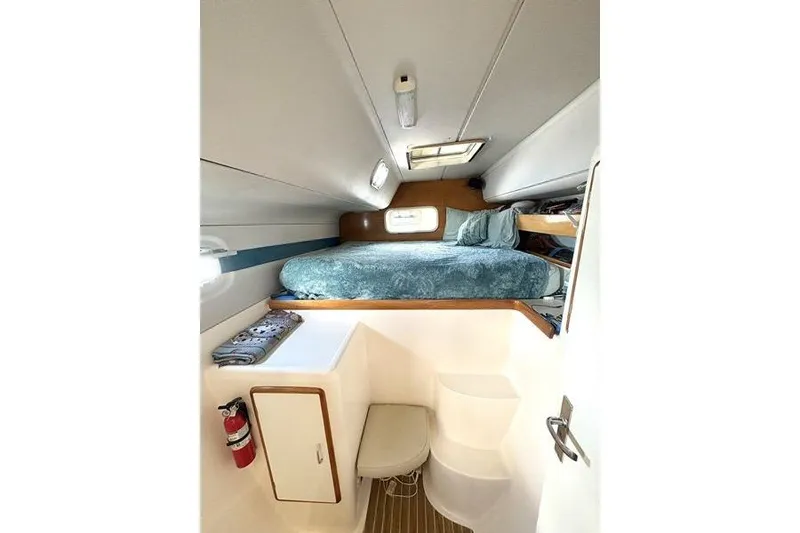 Slide: The Image of 1998 Leopard Catamaran interior cabin with bed, storage, and natural light. - 42