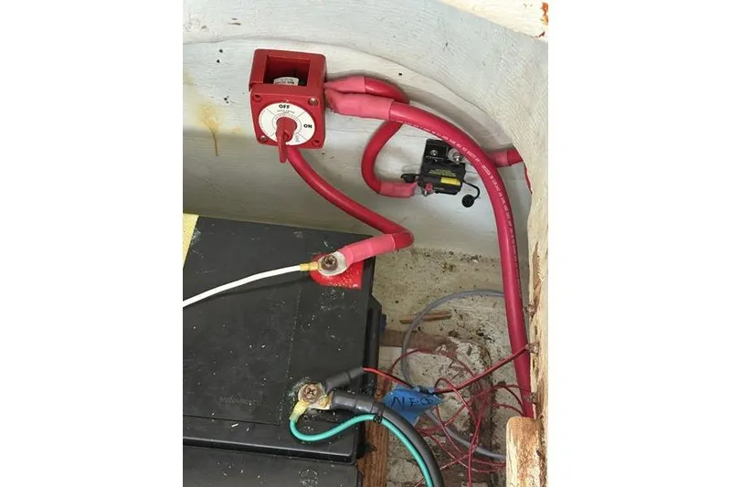 Slide: The Image of Electrical setup in a 1998 Leopard Catamaran, featuring battery and wiring connections. - 47