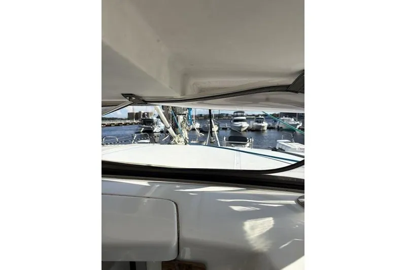 Slide: The Image of 1998 Leopard Catamaran interior view with marina and boats in the background. - 49