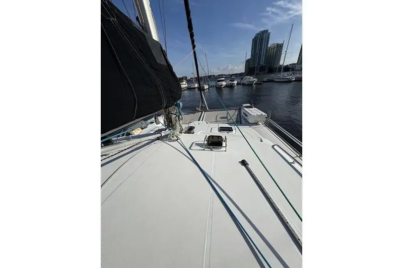Slide: The Image of 1998 Leopard Catamaran deck view in marina with city skyline background. - 54